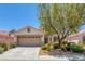 Charming single-story home with well-maintained front yard, mature shade tree, and two-car garage at 4369 Meadowlark Wing Way, North Las Vegas, NV 89084