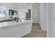 Stylish kitchen with quartz countertops and green cabinets, open to the entryway and living spaces at 4369 Meadowlark Wing Way, North Las Vegas, NV 89084