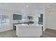 Bright and modern kitchen with quartz countertops, green cabinetry, and stainless steel appliances at 4369 Meadowlark Wing Way, North Las Vegas, NV 89084