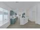 Beautiful kitchen with views into great room, green cabinets and an island at 4369 Meadowlark Wing Way, North Las Vegas, NV 89084