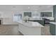 Well-lit kitchen with large island, stainless steel appliances, and modern cabinetry at 4369 Meadowlark Wing Way, North Las Vegas, NV 89084