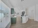 Spacious kitchen featuring stainless steel appliances, green cabinets, and hardwood-style flooring at 4369 Meadowlark Wing Way, North Las Vegas, NV 89084