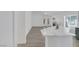 Spacious open floorplan with vaulted ceilings, wood-look floors, and fireplace, open to kitchen at 4369 Meadowlark Wing Way, North Las Vegas, NV 89084