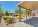 Covered patio area with beautiful landscaping and desert rock at 4369 Meadowlark Wing Way, North Las Vegas, NV 89084