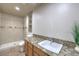 Bright bathroom features a granite countertop, modern sink, and tiled walk-in shower at 4428 Los Reyes Ct, Las Vegas, NV 89121