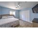 Cozy bedroom with blue walls, wood-look floors, and a ceiling fan at 4428 Los Reyes Ct, Las Vegas, NV 89121