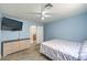 Bedroom with light blue walls, wood-look floors, and a connecting bathroom at 4428 Los Reyes Ct, Las Vegas, NV 89121