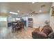 Open dining area features wood-look tile flooring, modern lighting, and a skylight for natural light at 4428 Los Reyes Ct, Las Vegas, NV 89121