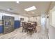 Bright and airy dining area with stainless steel refrigerator, a skylight, and wood-look flooring at 4428 Los Reyes Ct, Las Vegas, NV 89121