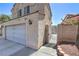 Side view of the residence showing the two car garage and gated side entrance at 4428 Los Reyes Ct, Las Vegas, NV 89121