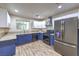 Beautiful kitchen featuring stainless steel appliances, blue cabinetry, and a garden view window at 4428 Los Reyes Ct, Las Vegas, NV 89121