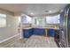 Updated kitchen showcasing modern appliances, stylish blue lower cabinets, and granite countertops at 4428 Los Reyes Ct, Las Vegas, NV 89121