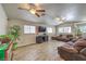 Bright living room with tile flooring, ceiling fans, and large windows allowing ample natural light at 4428 Los Reyes Ct, Las Vegas, NV 89121