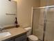 Bathroom featuring a granite vanity and tiled walk-in shower with glass door at 4555 E Sahara Ave # 288, Las Vegas, NV 89104