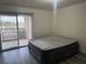 Bedroom with wood-style flooring and slider access to balcony at 4555 E Sahara Ave # 288, Las Vegas, NV 89104