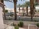 Exterior view displaying the community's landscape with lush palm trees and surrounding buildings at 4555 E Sahara Ave # 288, Las Vegas, NV 89104