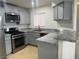 Well-equipped kitchen featuring stainless steel appliances, granite countertops, and tiled flooring at 4555 E Sahara Ave # 288, Las Vegas, NV 89104