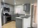 Updated kitchen with gray cabinets, stainless steel appliances, and granite countertops at 4555 E Sahara Ave # 288, Las Vegas, NV 89104