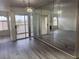 Open floor plan with a mirrored wall, slider to balcony, and updated lighting at 4555 E Sahara Ave # 288, Las Vegas, NV 89104