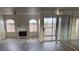 Spacious living room featuring a fireplace, balcony, and modern lighting at 4555 E Sahara Ave # 288, Las Vegas, NV 89104
