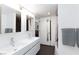 Contemporary bathroom features dual sinks, gray tile, and ample lighting at 4778 Knotty Pine Way, Las Vegas, NV 89124