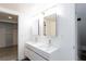 The bathroom has double sinks and mirrors at 4778 Knotty Pine Way, Las Vegas, NV 89124