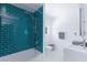 Bathroom with blue tile shower, white hexagon tile floors, and modern vanity at 4778 Knotty Pine Way, Las Vegas, NV 89124
