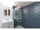 Sleek bathroom featuring a glass-enclosed shower with textured tile, modern vanity, and stylish fixtures at 4778 Knotty Pine Way, Las Vegas, NV 89124