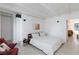 Bright bedroom with white walls, wood-beam ceiling, simple furnishings, and hardwood-style floors at 4778 Knotty Pine Way, Las Vegas, NV 89124