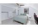 Cozy bedroom with hardwood floors, a ceiling fan, a closet and a large window at 4778 Knotty Pine Way, Las Vegas, NV 89124