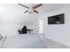 Bedroom with white walls, light hardwood floors, ceiling fan and view of the tv at 4778 Knotty Pine Way, Las Vegas, NV 89124