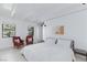Bright bedroom features white walls, wood-beam ceiling, large windows, and sleek, modern furnishings at 4778 Knotty Pine Way, Las Vegas, NV 89124