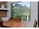 Dining area showcasing a window view of the mountains and a stone fireplace at 4778 Knotty Pine Way, Las Vegas, NV 89124