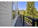 Exterior view of a balcony with metal railings, showcasing mountain views and lush greenery at 4778 Knotty Pine Way, Las Vegas, NV 89124