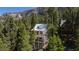 Exterior view of the home nestled among tall trees, offering privacy and seclusion at 4778 Knotty Pine Way, Las Vegas, NV 89124