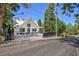 Exterior shot of a charming white home with an A-frame roof, stone driveway, and basketball hoop at 4778 Knotty Pine Way, Las Vegas, NV 89124
