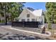 Charming white exterior with an A-frame roof, covered porch, a stone paver driveway, and a basketball hoop at 4778 Knotty Pine Way, Las Vegas, NV 89124