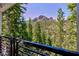 Breathtaking mountain views from the deck with plenty of green trees and blue sky at 4778 Knotty Pine Way, Las Vegas, NV 89124