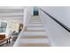 Stairwell leading to the next level with stone fireplace and seating area in the background at 4778 Knotty Pine Way, Las Vegas, NV 89124