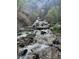 Beautiful water feature with cascading streams and lush greenery at 4778 Knotty Pine Way, Las Vegas, NV 89124