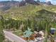 Scenic aerial view of a wooded mountain neighborhood, featuring cozy cabins with green roofs and mountain views at 4830 Silver Tip Way, Mount Charleston, NV 89124