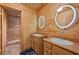 Bathroom boasts double sinks with round light-up mirrors and tiled shower at 4830 Silver Tip Way, Mount Charleston, NV 89124