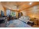 Versatile bedroom with wood paneling, desk, sleeper sofa, and ample space for relaxation at 4830 Silver Tip Way, Mount Charleston, NV 89124