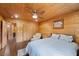 Comfortable bedroom with wood paneling, hardwood floors, and ample closet space at 4830 Silver Tip Way, Mount Charleston, NV 89124