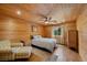 Inviting bedroom with wood paneling, hardwood floors, and cozy furniture at 4830 Silver Tip Way, Mount Charleston, NV 89124