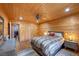 Bedroom featuring wood paneling, hardwood floors, and contemporary furnishings at 4830 Silver Tip Way, Mount Charleston, NV 89124