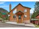Charming two-story cabin with a green roof nestled in a mountain setting with a street view at 4830 Silver Tip Way, Mount Charleston, NV 89124