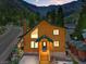 Charming two-story cabin with a green roof nestled in a mountain setting with a street view at 4830 Silver Tip Way, Mount Charleston, NV 89124