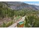 Beautiful home surrounded by nature with a green roof nestled in a mountain landscape at 4830 Silver Tip Way, Mount Charleston, NV 89124