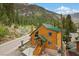 Inviting cabin exterior with a wooden staircase leading to the front door and mountain views at 4830 Silver Tip Way, Mount Charleston, NV 89124